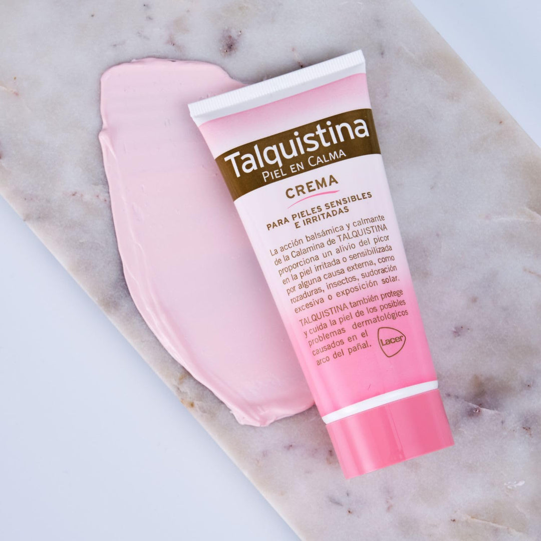 Tube of Talquistina Calamine Cream beside soothing pink calamine powder