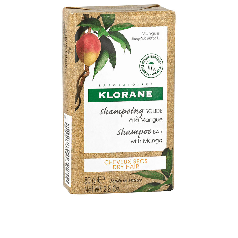 Brown and green cardboard shampoo bar box with mango illustration, biodegradable icon, Klorane branding visible