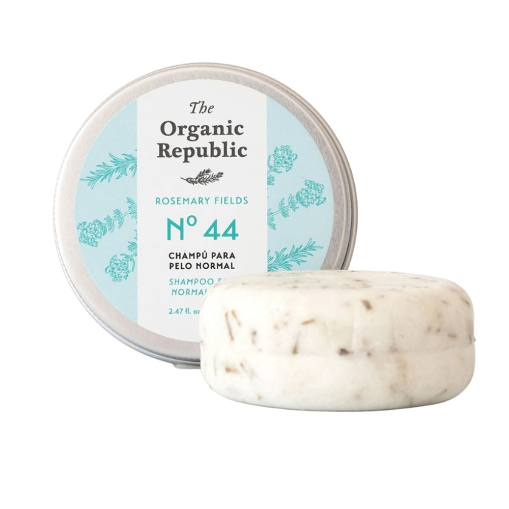 Small round solid shampoo bar, rosemary sprig and thyme beside it, 70 g packaging