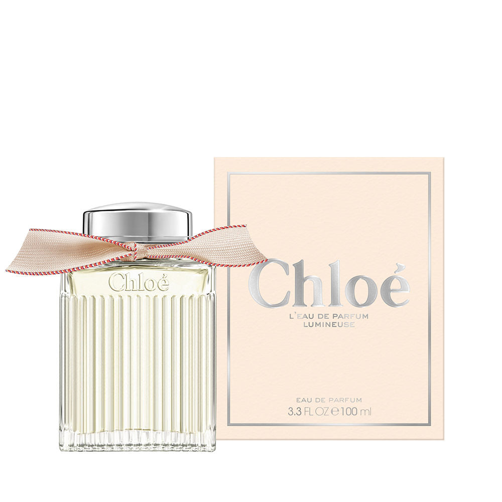 50 ml clear glass perfume bottle with beige ribbon and silver cap, floral scent