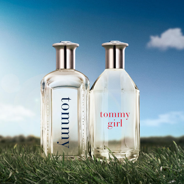 Clear curved 100 ml perfume bottle with silver cap, floral-woody scent for Women