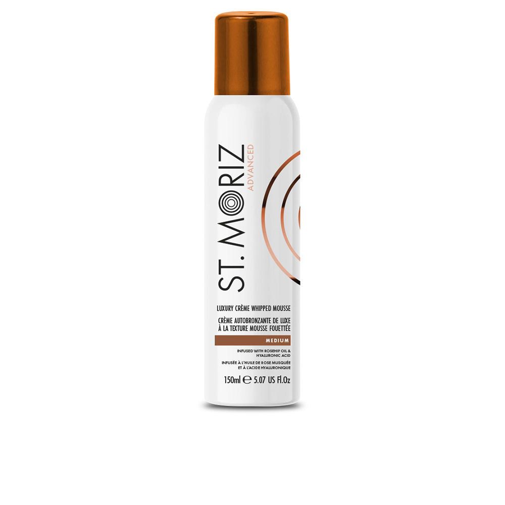 St. Moriz White and copper cylindrical plastic spray bottle with metallic cap and whipped mousse beside it, expert, refined.