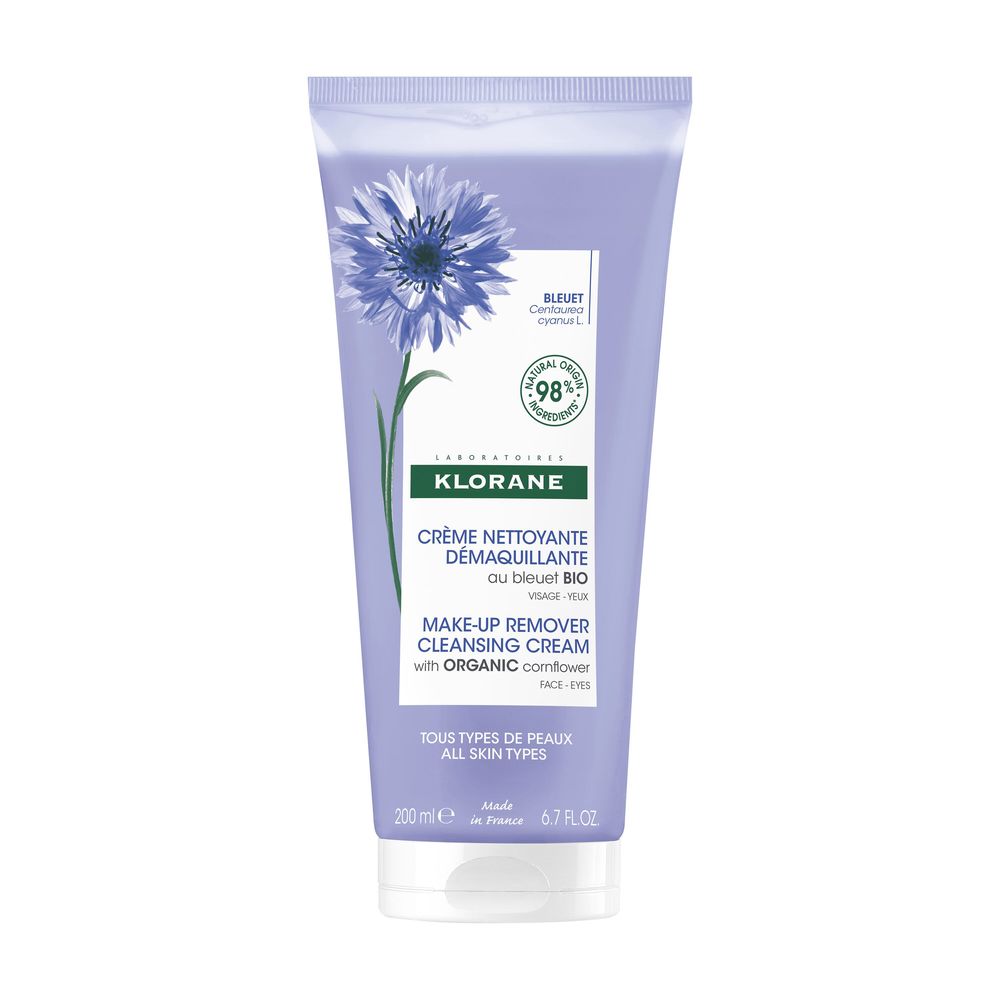 Plastic tube of white face cream with blue floral graphic, printed front text and screw cap, Klorane