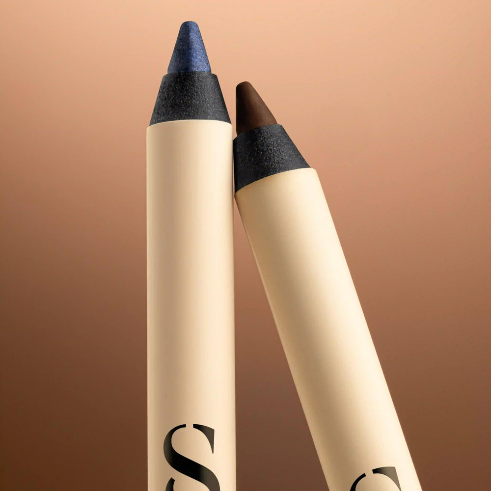 Sensilis beige and blue eyeliner pencil with slim cylindrical body, blue caps, and black printed logo