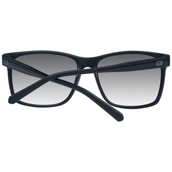 Black rectangular sunglasses on neutral background with gradient lenses and visible logo on temple