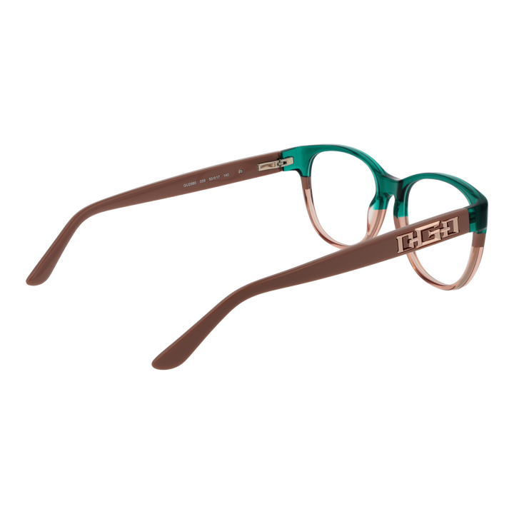 Green and brown two-tone cat-eye eyeglasses in plastic with metal logo on temples, front three-quarter view
