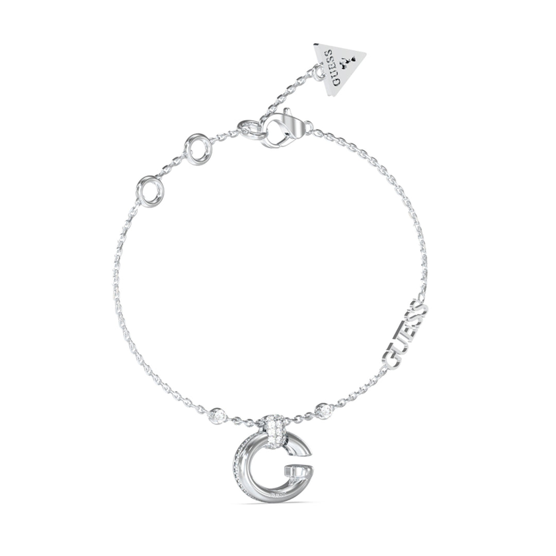 Delicate silver chain bracelet with stone-set G charm and GUESS logo charm on neutral background