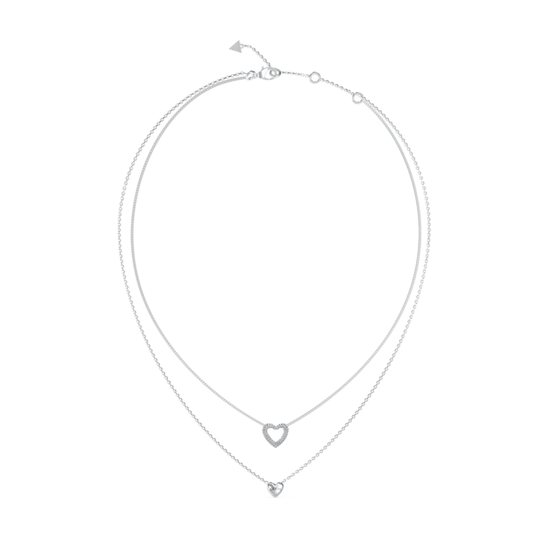Double-layered silver necklace with two heart-shaped pendants on fine chains against neutral background