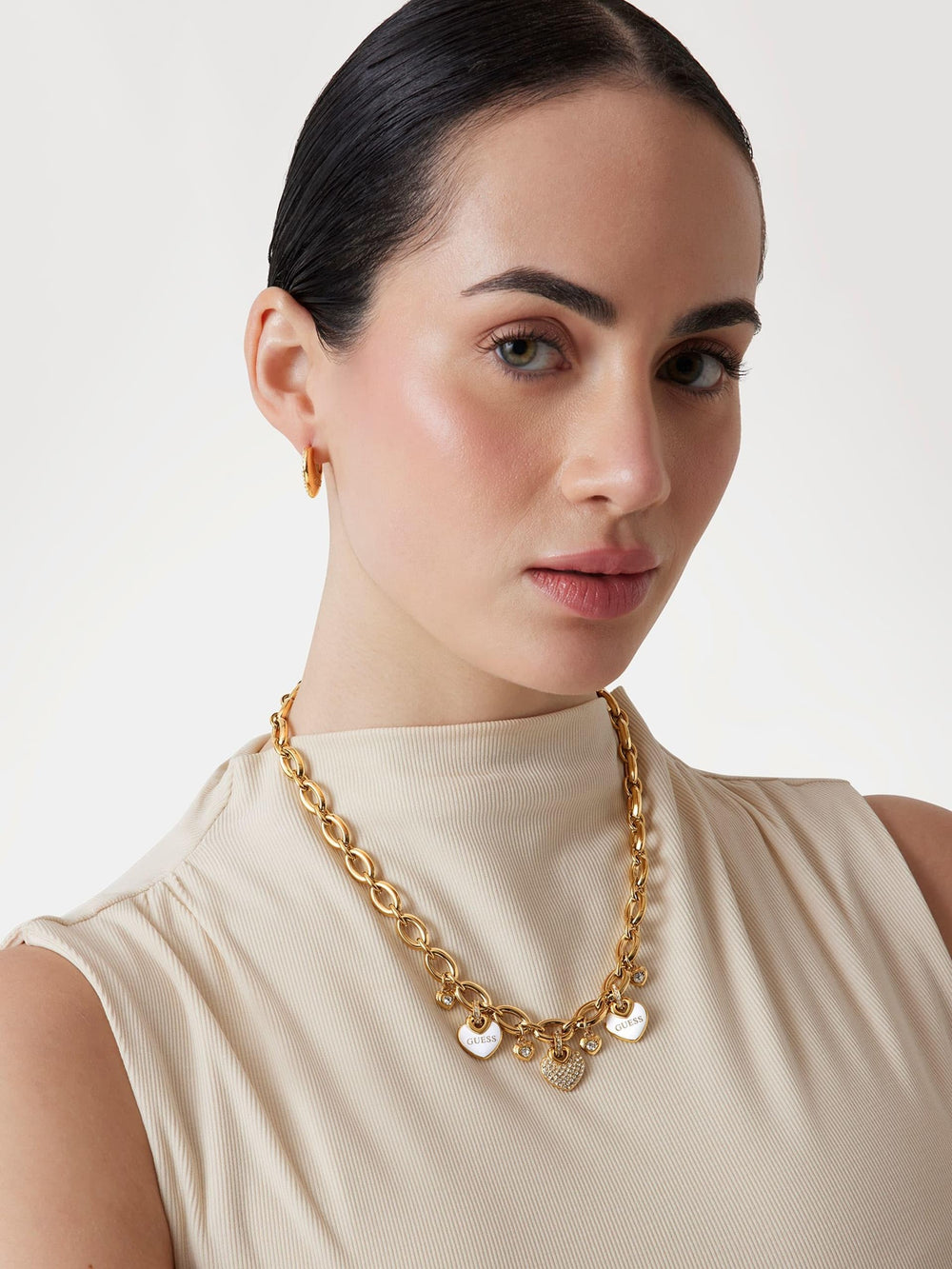 Gold-toned charm necklace for Women with heart-shaped rhinestone charms on link chain