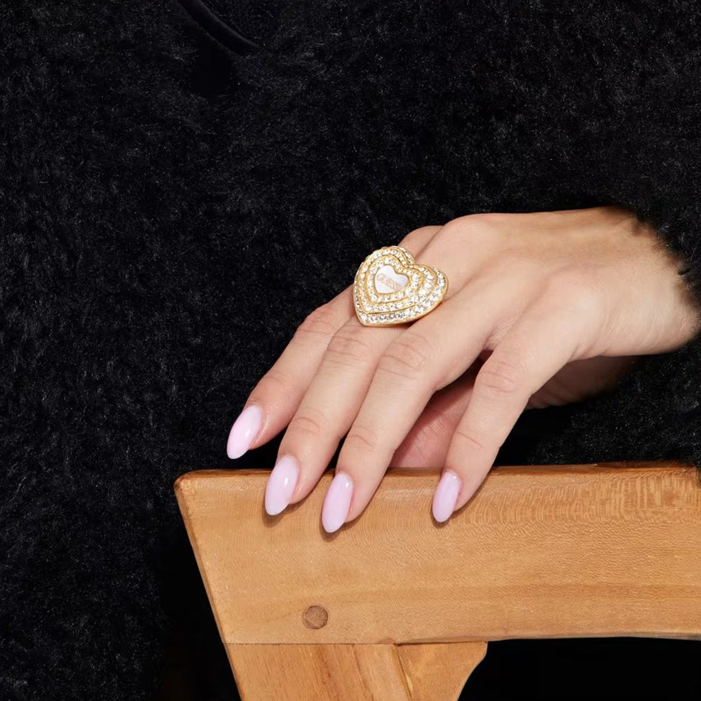 Gold layered heart ring for Women with clear pavé stones and polished metal band in studio light