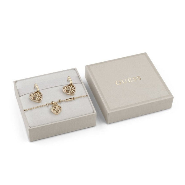 Gold heart pendant necklace, matching chain bracelet and hook earrings on beige background