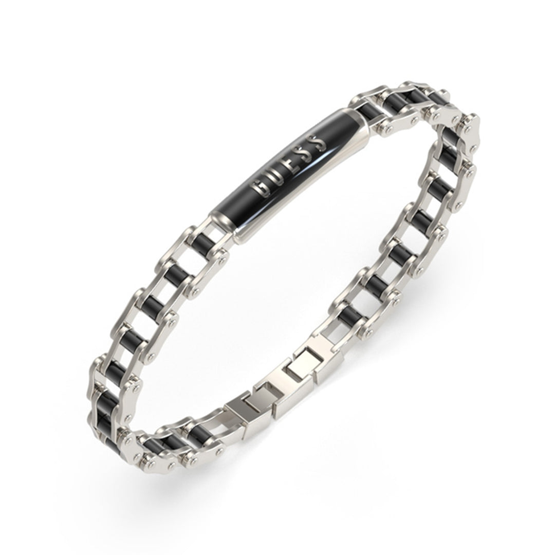 Silver and black metal chain bracelet with engraved Guess plate on a dark background