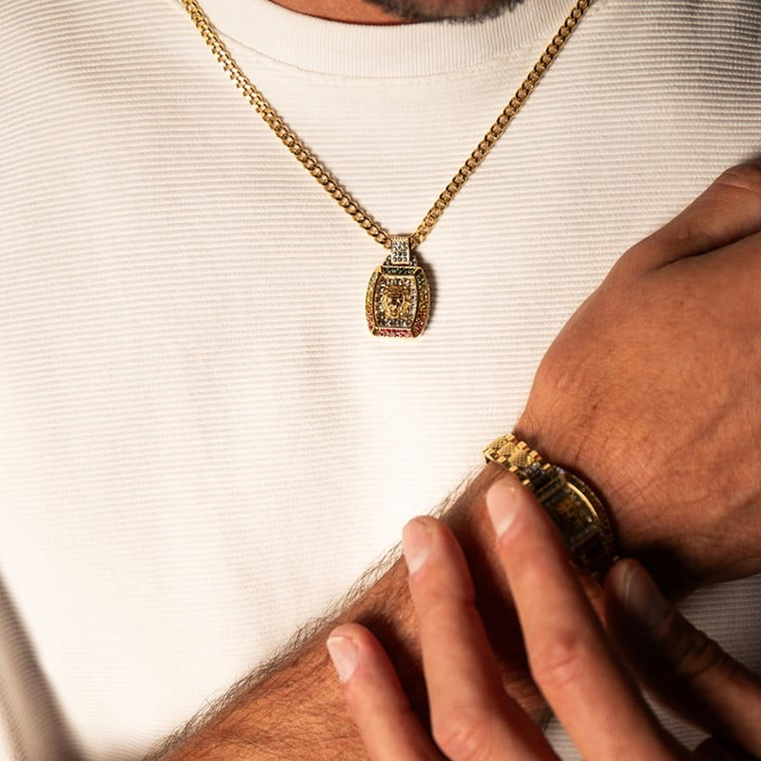 Gold lion head pendant on medium chain with multicolor accents, shown against neutral background