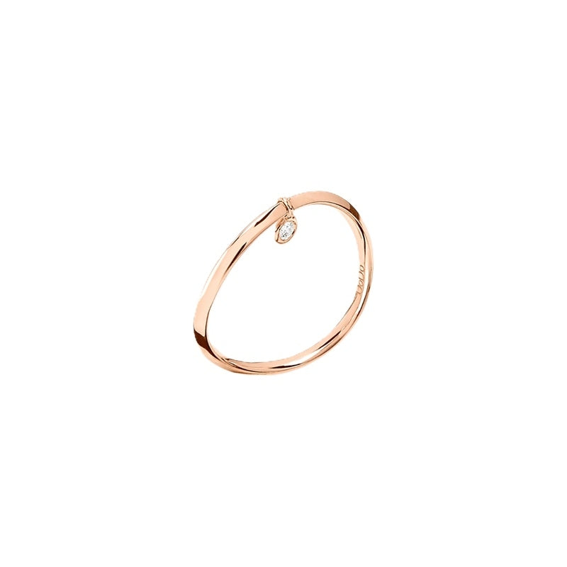 Rose gold slim bangle featuring a single dangling clear diamond charm on a neutral background