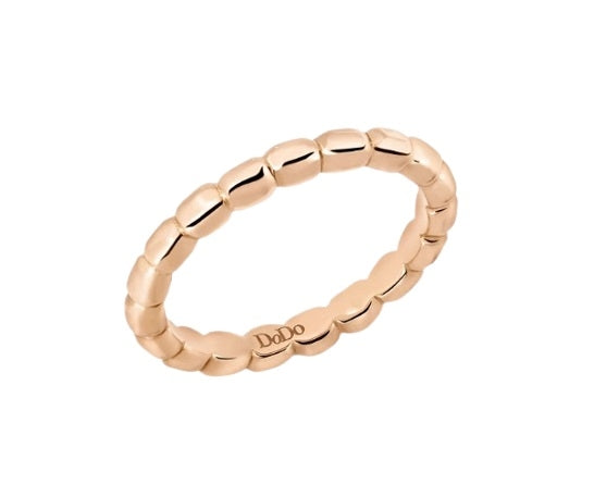 Slim rose gold beaded ring on neutral background, close-up showing polished beaded texture and slim band