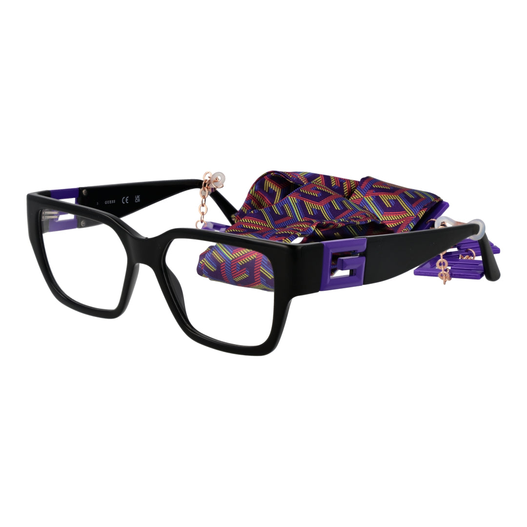 Black square plastic eyeglasses with purple multicolor fabric strap and metal charm chain on a neutral background.